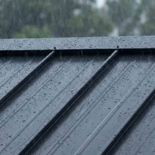 Metal roof with water droplets during rain, showcasing durability and weather resistance relevant to Texas roofing considerations.