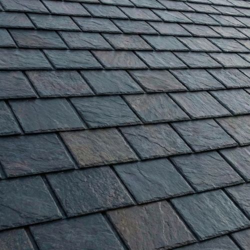 Metal roof resembling slate tiles, showcasing aesthetic versatility for Texas homes, emphasizing durability and energy efficiency.